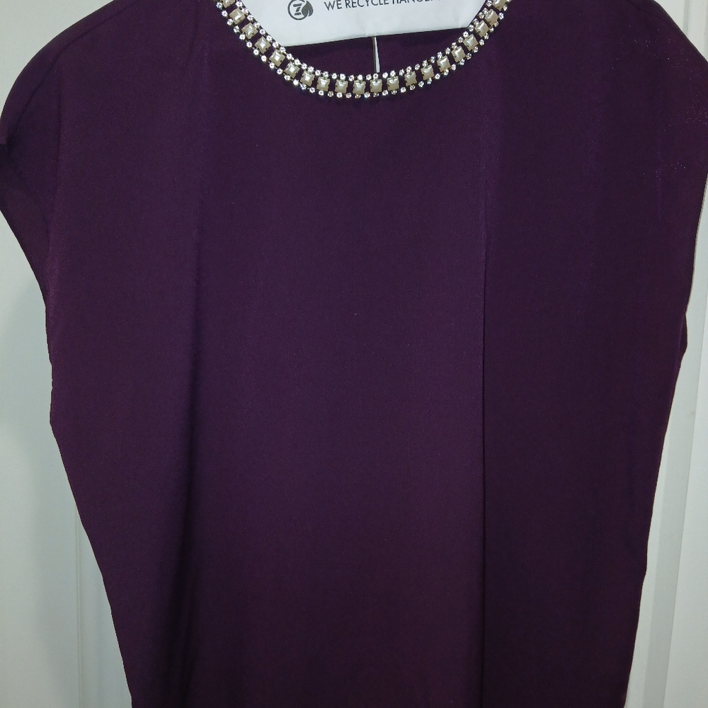 Top with rhinestone  neckline.